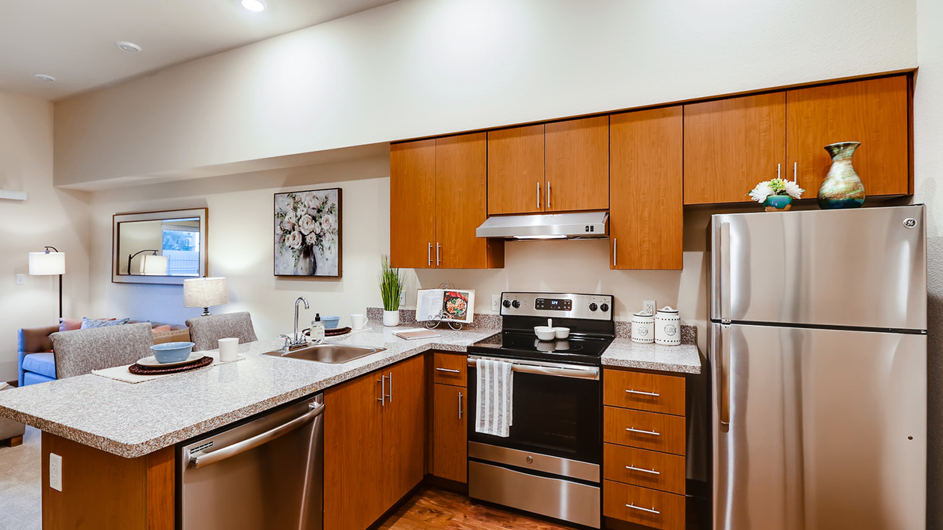 Holiday Westgate Village apartment kitchen with full sized stainless steel appliances including refrigerator, dishwasher, and stove